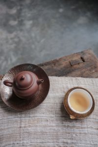 Yixing teapot and cup of tea on linen mat